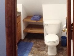 toilet, flooring, wood shelves